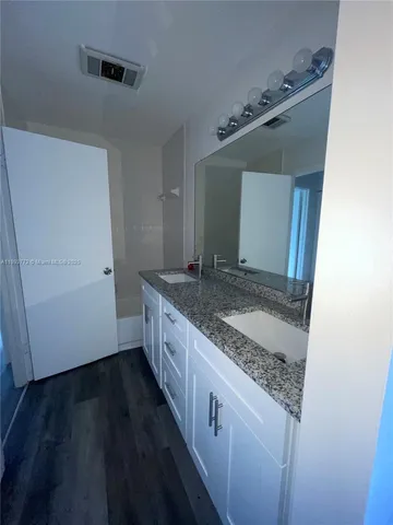 a kitchen with granite countertop a sink and a stove top oven