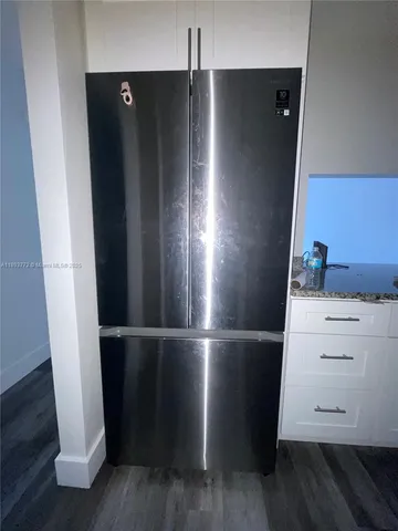 a view of walk in closet with wooden floor