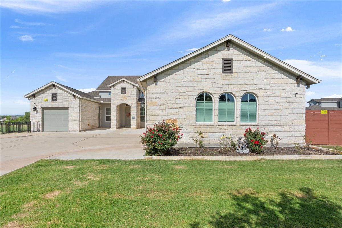 3625 Garrano Bend Leander, TX 78641 - Photo 2 of 38 A striking stone exterior with arched windows welcomes you to this attractive residence.