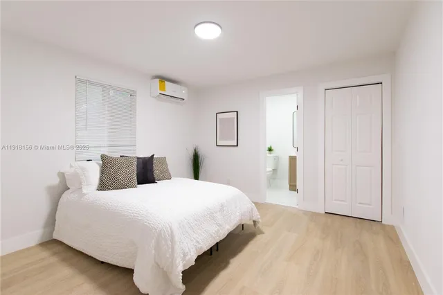 a bedroom with a bed and a painting