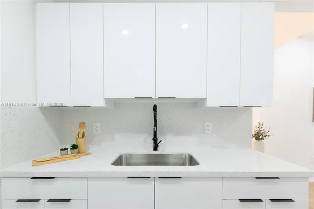a kitchen with a sink and cabinets