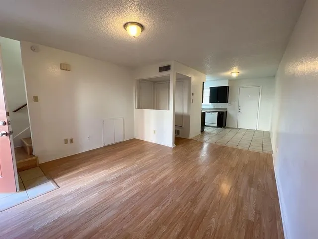 a view of a kitchen with a sink and a refrigerator