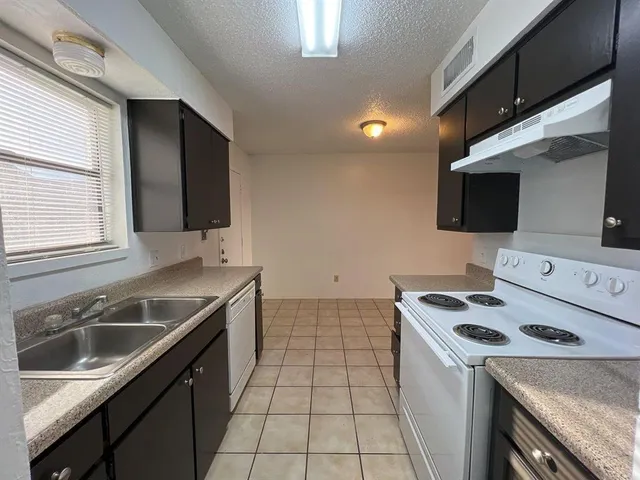 a kitchen with stainless steel appliances a sink and a refrigerator