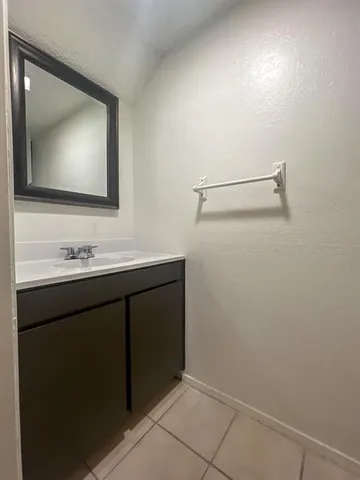 a view of empty room with wooden floor and fireplace