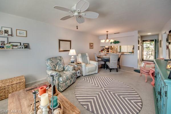 11110 Caravel Circle, Unit 205 Fort Myers, FL 33908 - Photo 11 of 45 a living room with furniture and a chandelier
