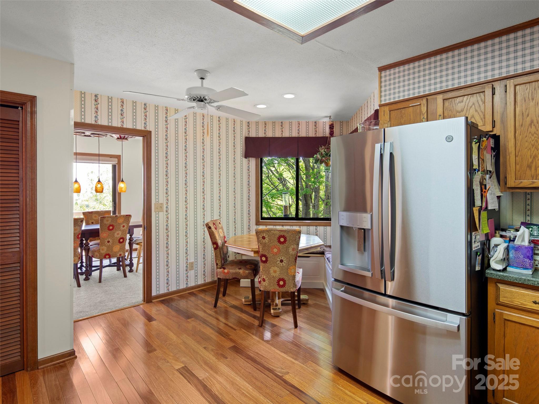 167 Country Ridge Road Laurel Park, NC 28739 - Photo 17 of 27 a kitchen with stainless steel appliances a refrigerator and wooden floor