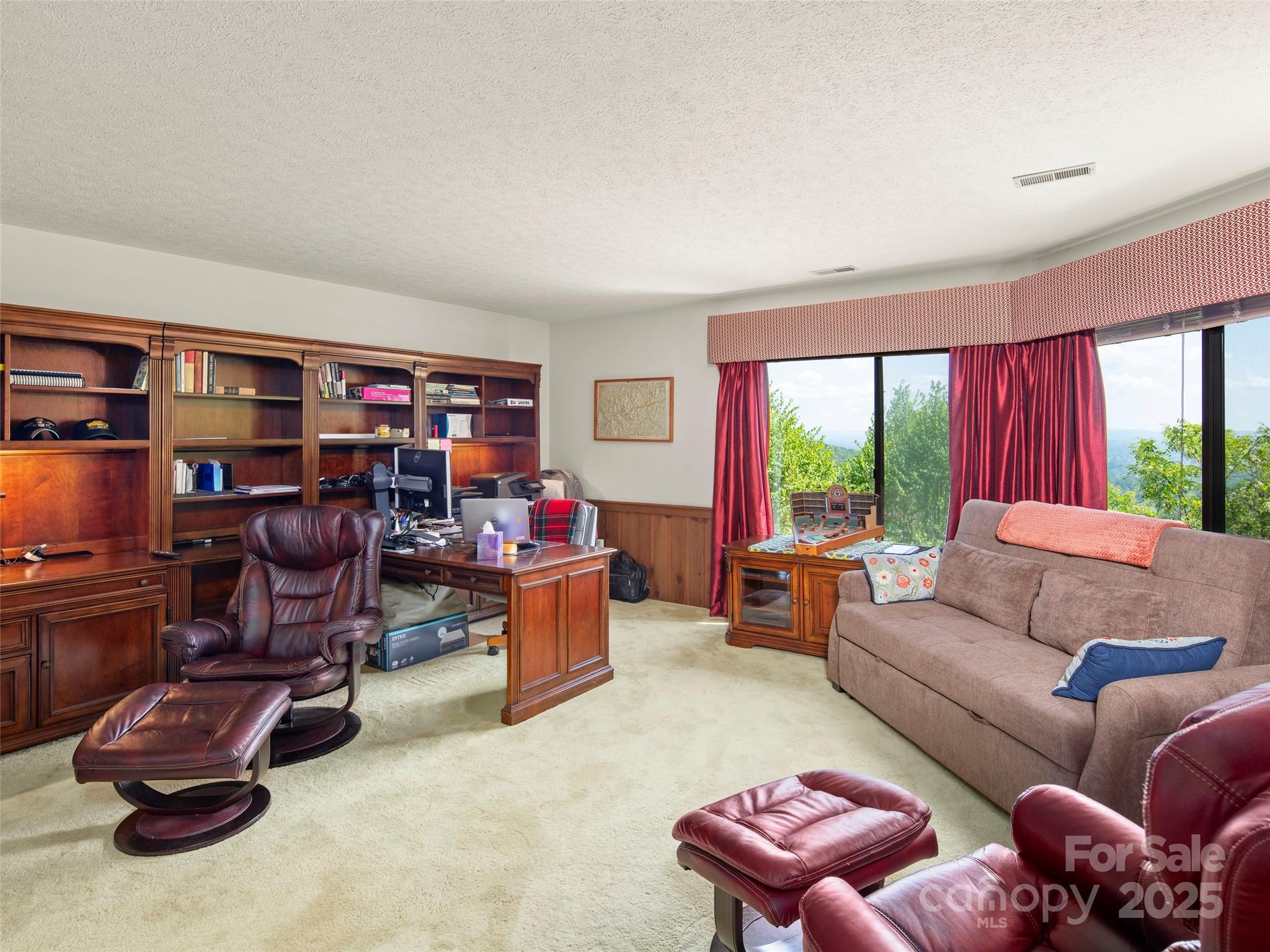 167 Country Ridge Road Laurel Park, NC 28739 - Photo 22 of 27 a living room with furniture a large window and gym equipment