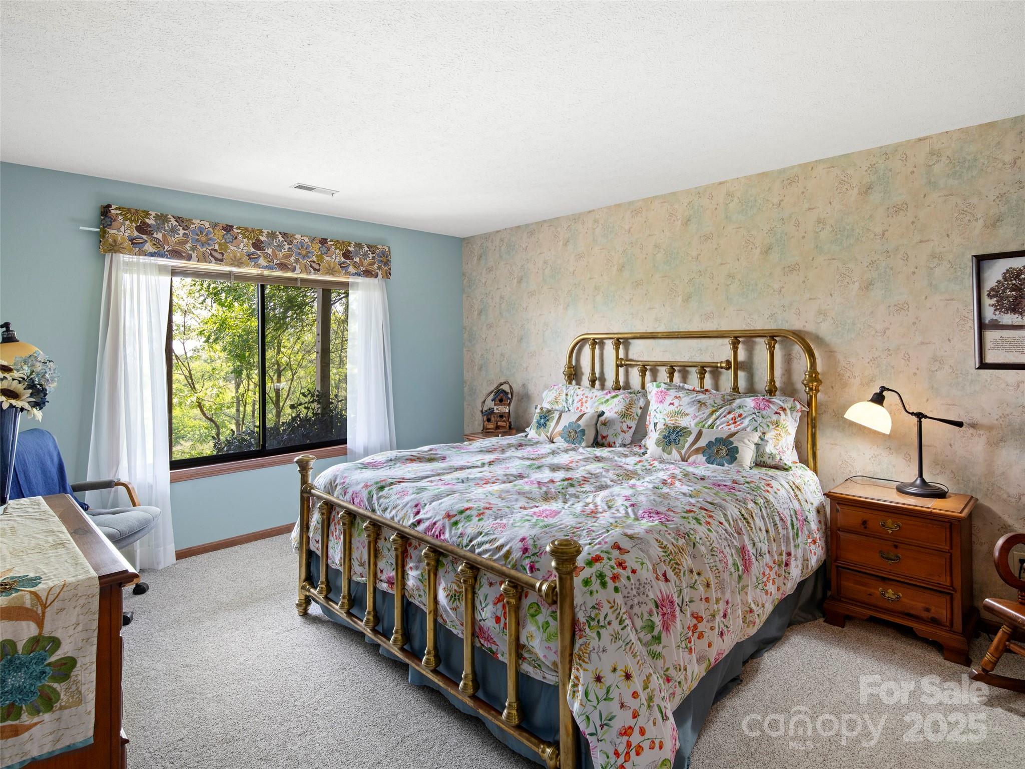 167 Country Ridge Road Laurel Park, NC 28739 - Photo 23 of 27 a bedroom with a bed and a window