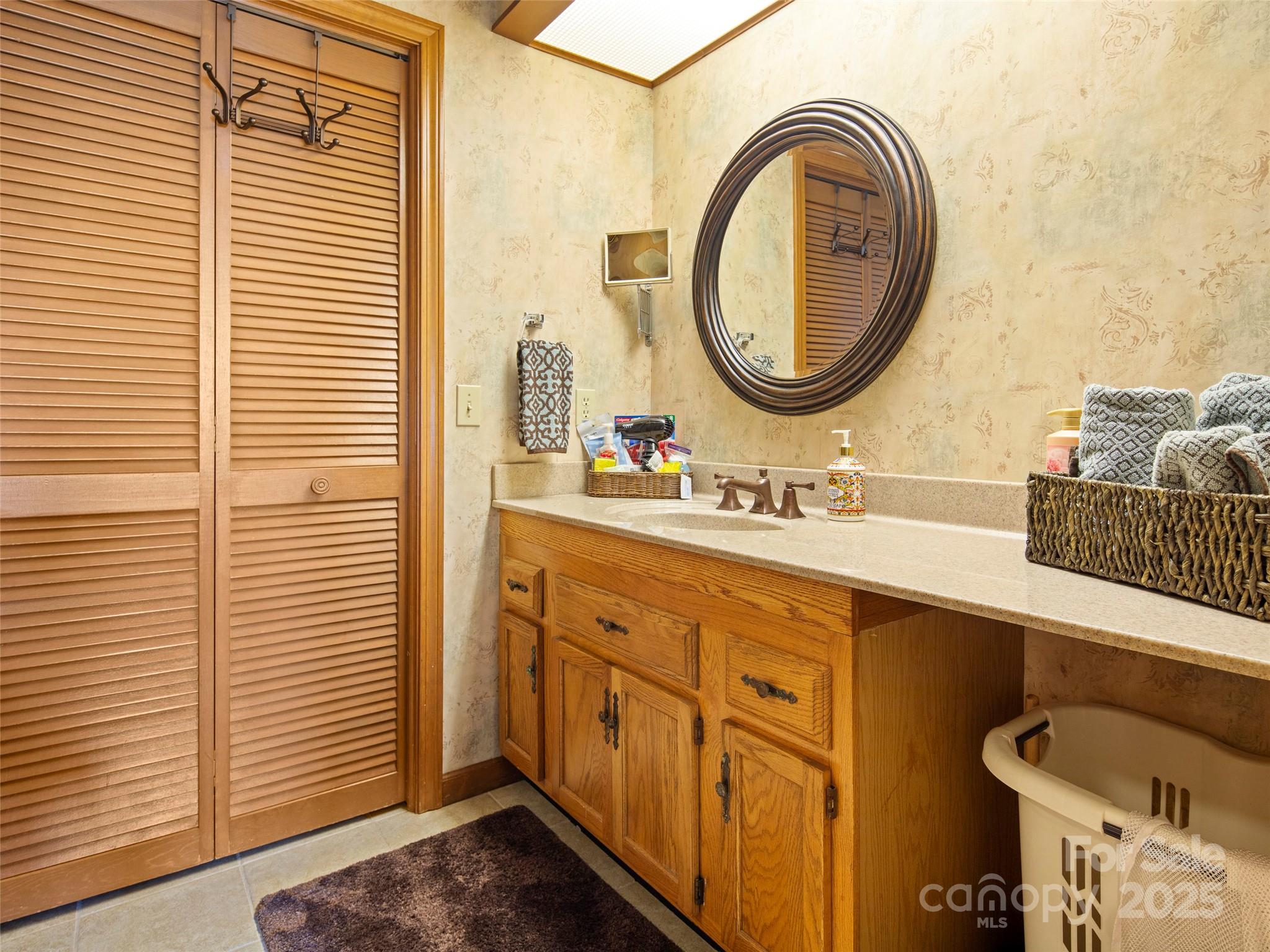 167 Country Ridge Road Laurel Park, NC 28739 - Photo 25 of 27 a bathroom with a sink a mirror and a toilet
