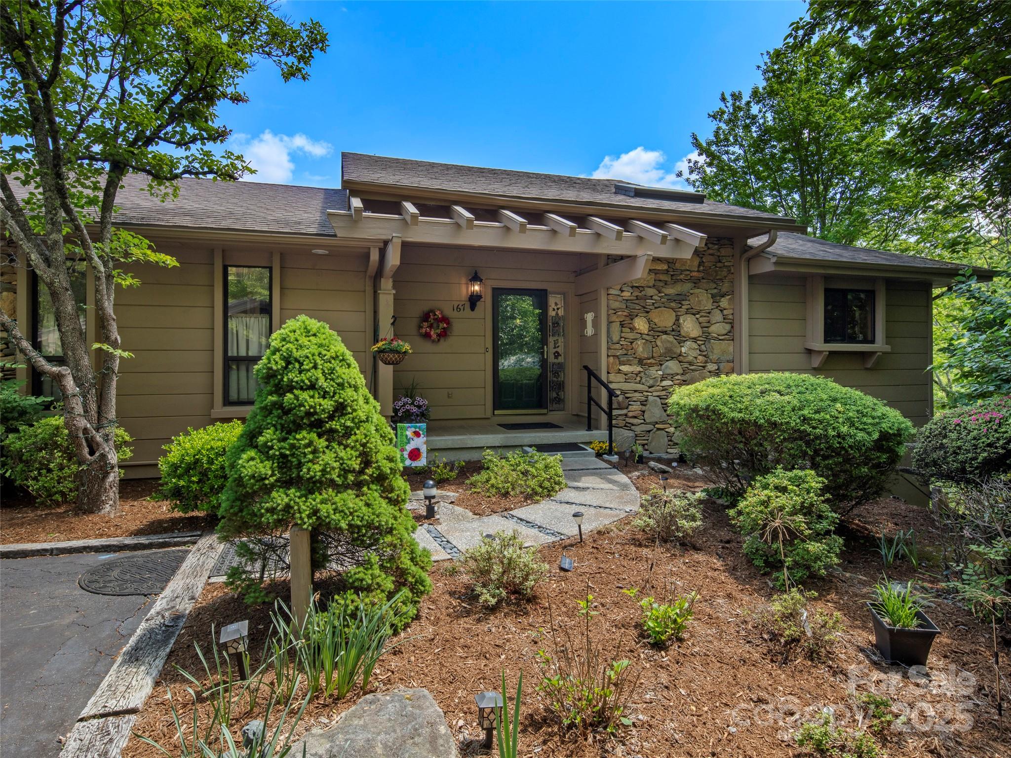 167 Country Ridge Road Laurel Park, NC 28739 - Photo 5 of 27 front view of a house with a yard