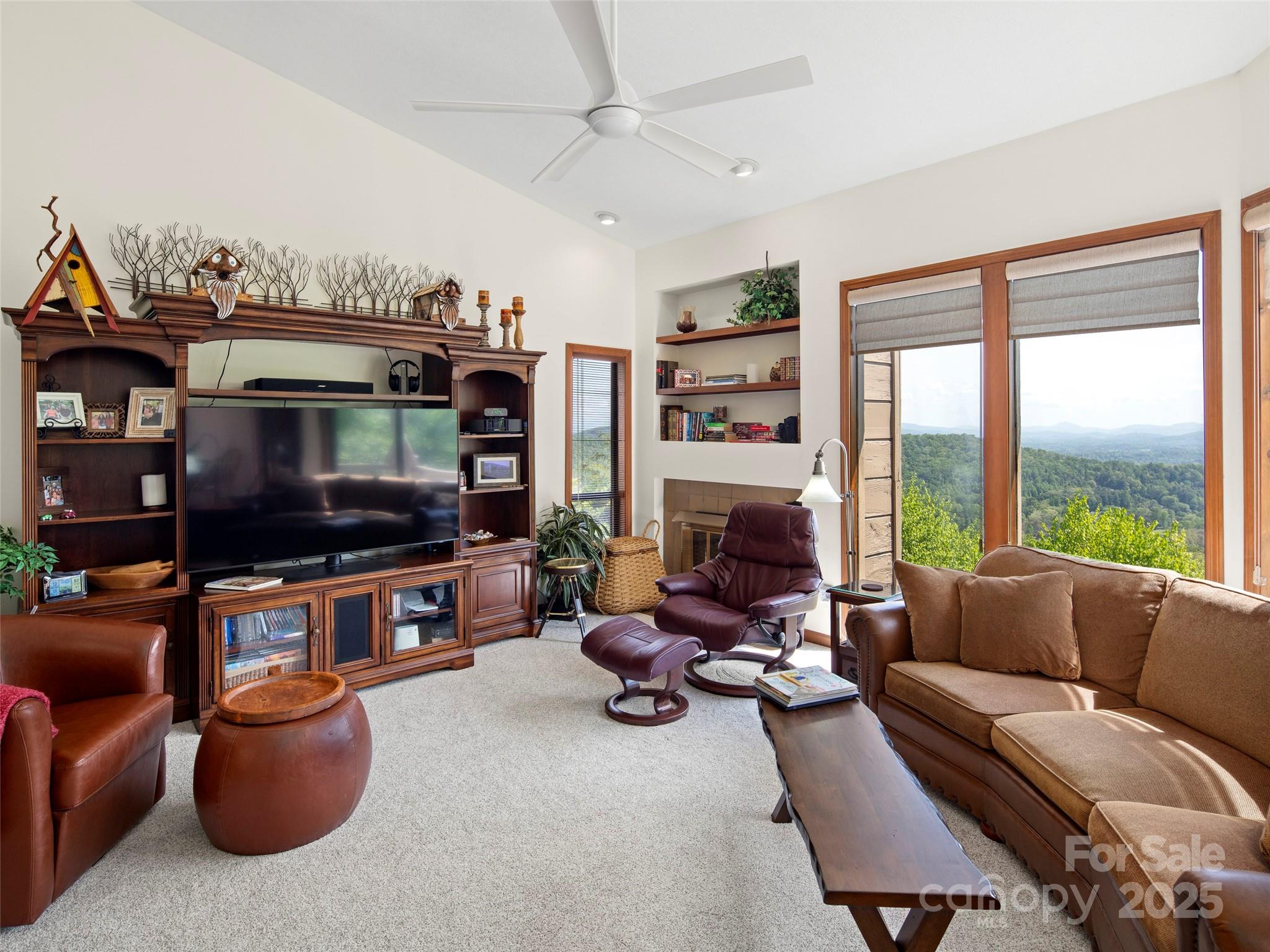 167 Country Ridge Road Laurel Park, NC 28739 - Photo 7 of 27 a living room with furniture a flat screen tv and a large window