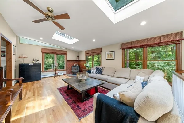 a living room with furniture large window and flat screen tv