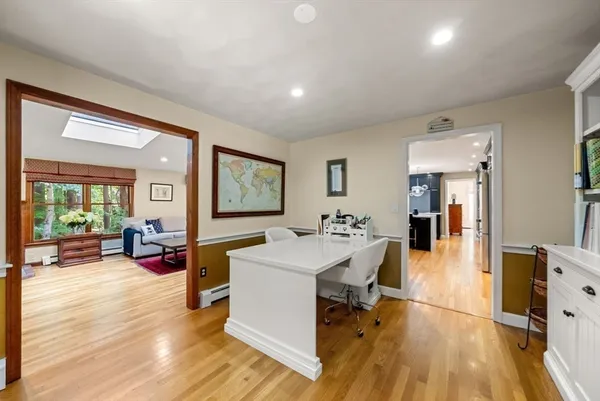 a living room with furniture a wooden floor and a large window