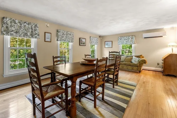 a view of a dining room with furniture and wooden floor