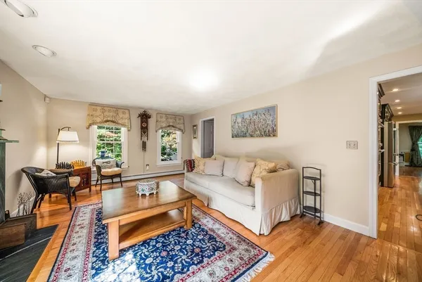 a living room with furniture and wooden floor