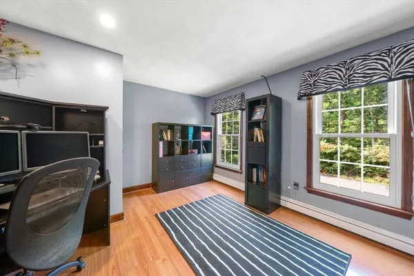 a bedroom with a bed and a large window