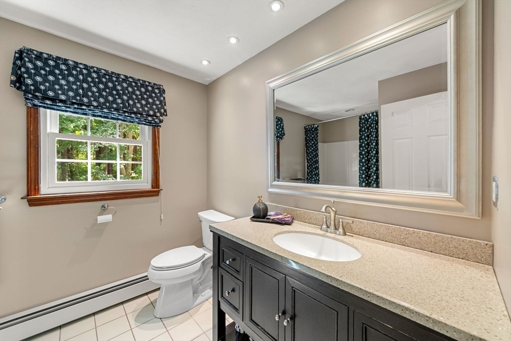 44 Gilmore Road Southborough, MA 01772 - Photo 30 of 42 a bathroom with a sink a toilet and a mirror