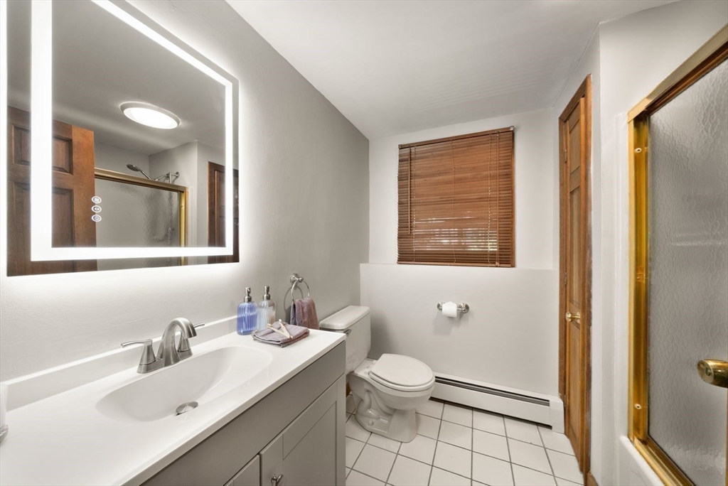 44 Gilmore Road Southborough, MA 01772 - Photo 35 of 42 a bathroom with a sink vanity granite toilet and a mirror
