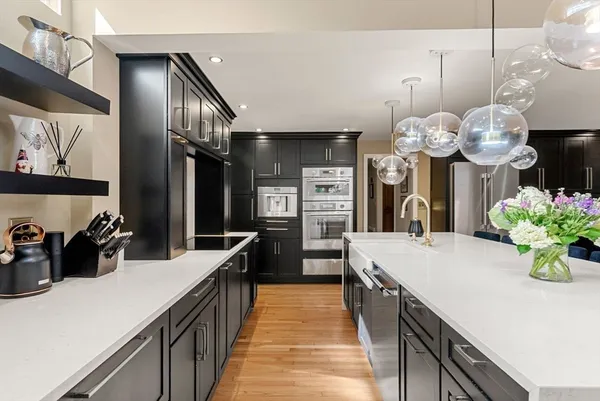 a kitchen with counter top space and wooden floor