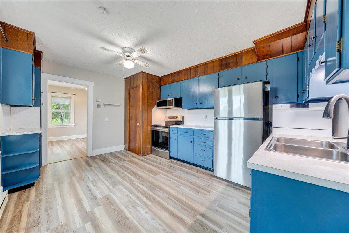 1384 Thaxton Mountain Road Thaxton, VA 24174 - Photo 15 of 44 a kitchen with refrigerator cabinets and wooden floor
