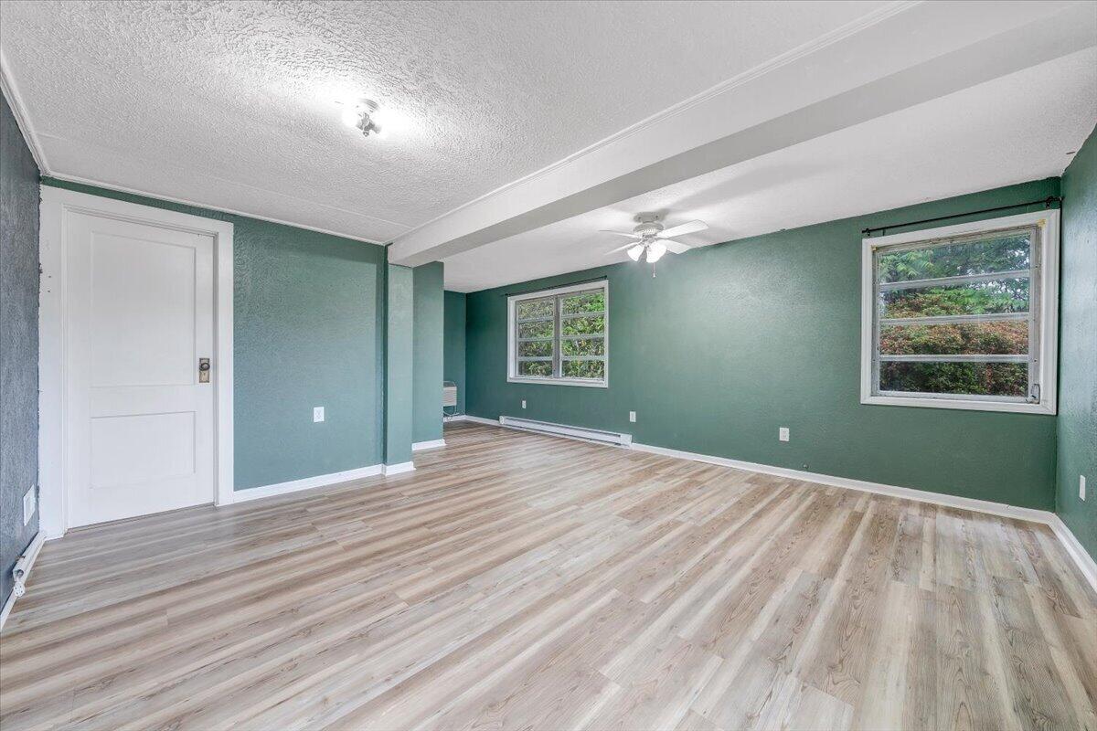 1384 Thaxton Mountain Road Thaxton, VA 24174 - Photo 16 of 44 a view of an empty room with wooden floor and a window