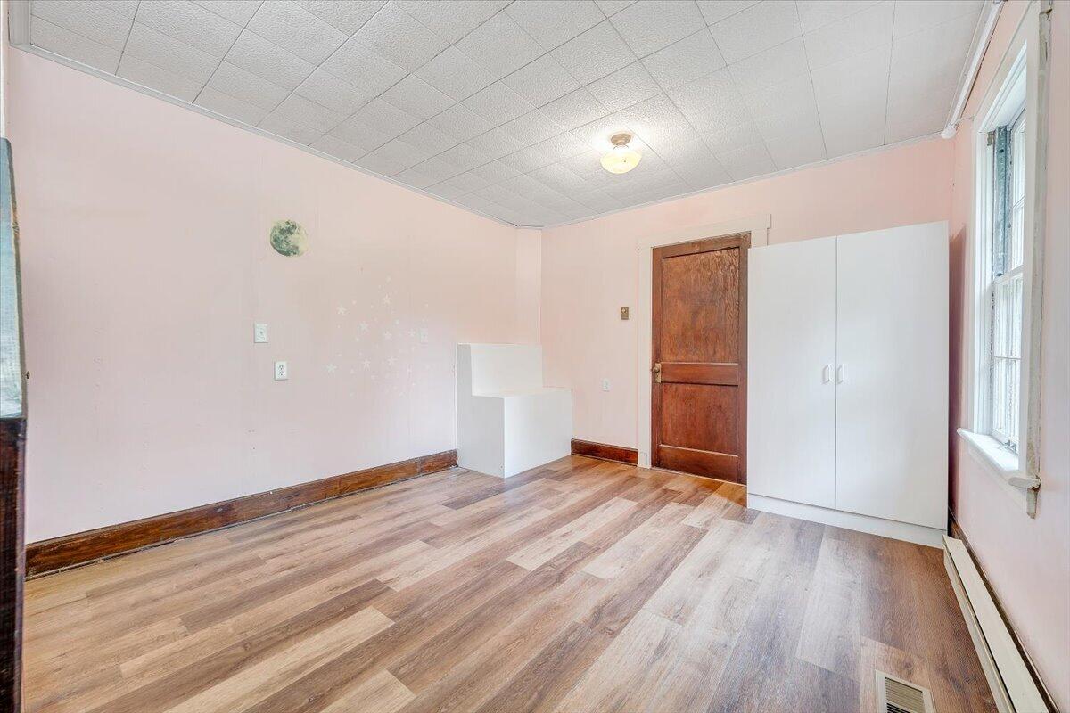 1384 Thaxton Mountain Road Thaxton, VA 24174 - Photo 26 of 44 a view of an empty room with wooden floor and a window