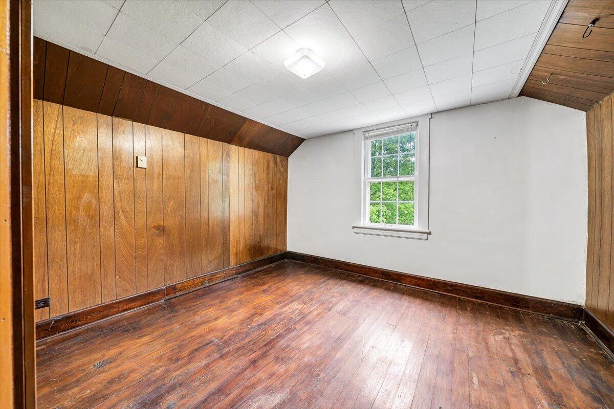 1384 Thaxton Mountain Road Thaxton, VA 24174 - Photo 31 of 44 a view of an empty room with wooden floor and a window