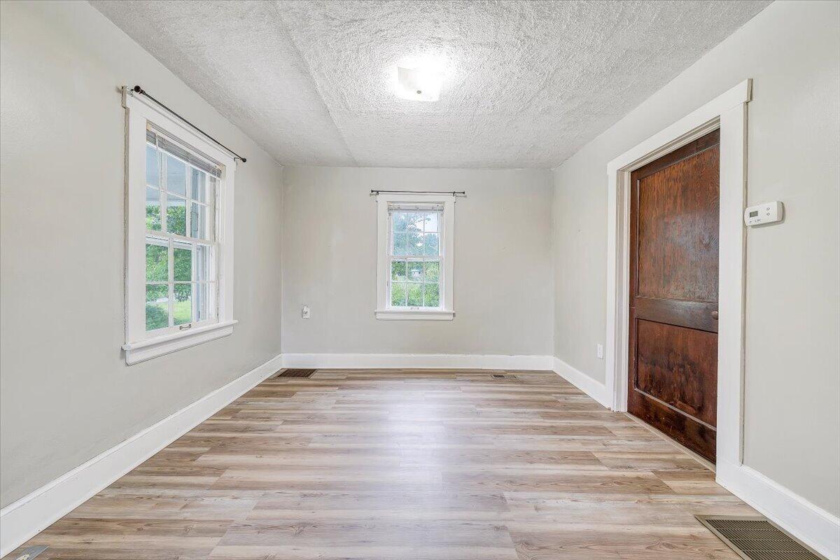 1384 Thaxton Mountain Road Thaxton, VA 24174 - Photo 6 of 44 an empty room with wooden floor and windows