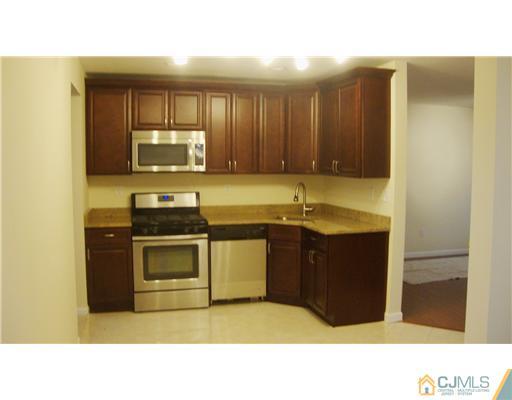 128 Idlewild Road Edison, NJ 08817 - Photo 3 of 9 a kitchen with sink and cabinets