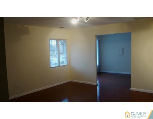 128 Idlewild Road Edison, NJ 08817 - Photo 5 of 9 a black and white photo of a living room