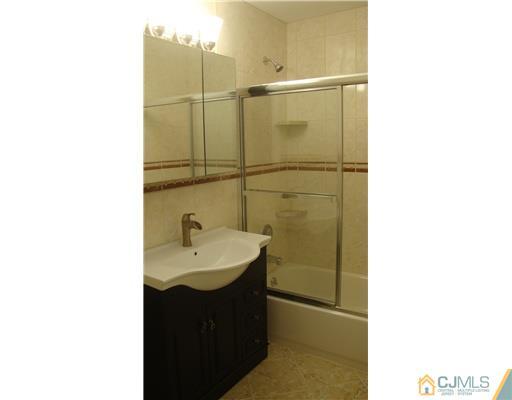 128 Idlewild Road Edison, NJ 08817 - Photo 7 of 9 a bathroom with a sink and a mirror