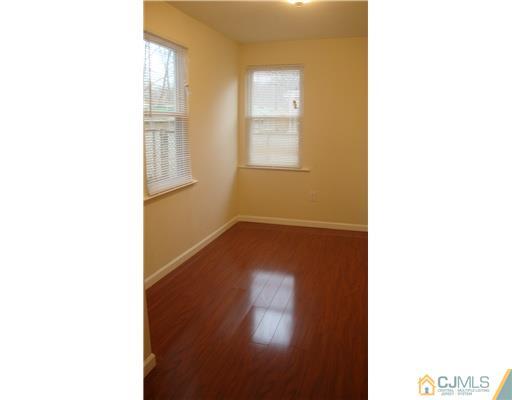 128 Idlewild Road Edison, NJ 08817 - Photo 8 of 9 a picture of a room with a window and wooden floor