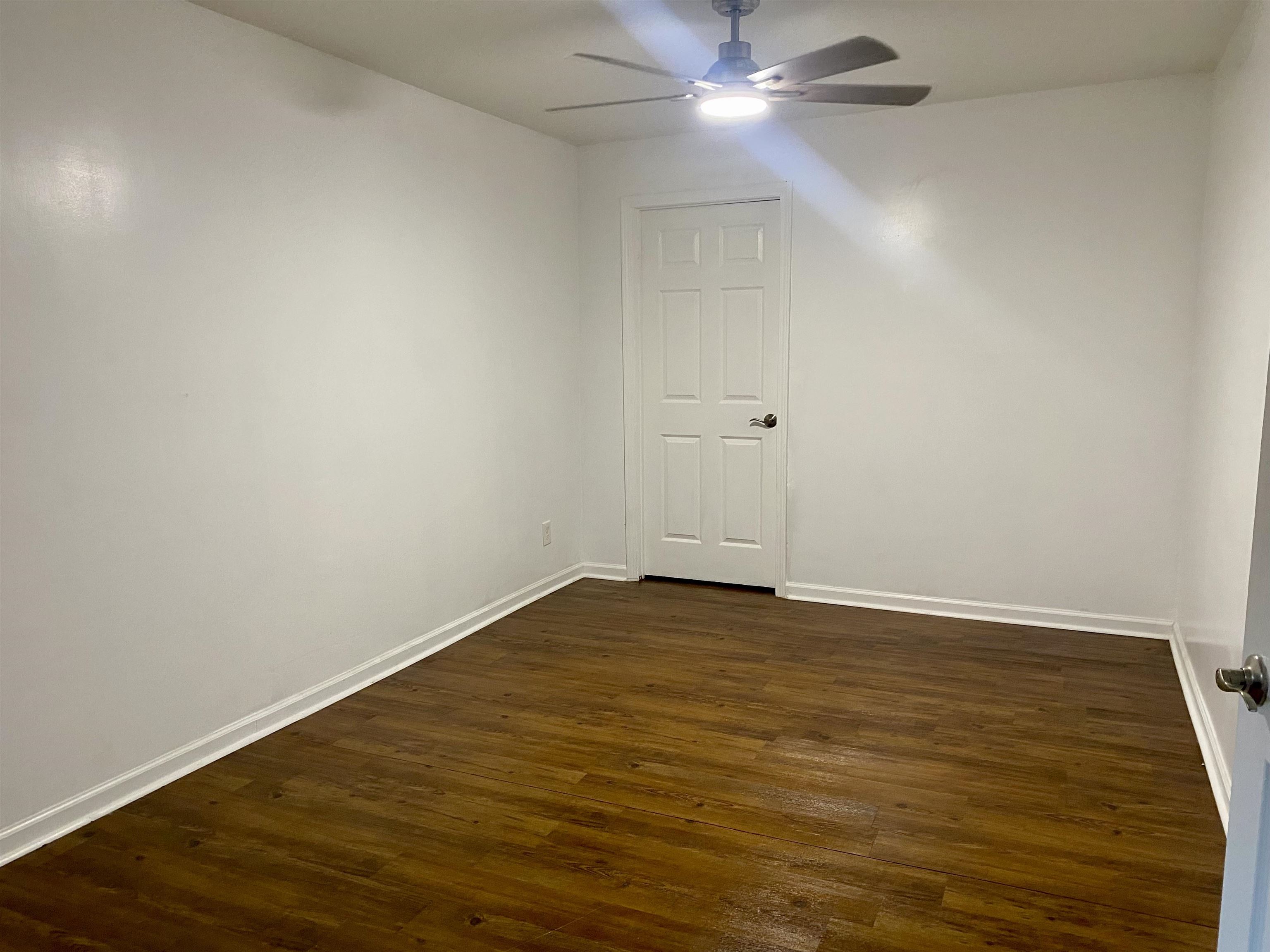 502 James Avenue Covington, TN 38019 - Photo 19 of 40 a view of an empty room with wooden floor