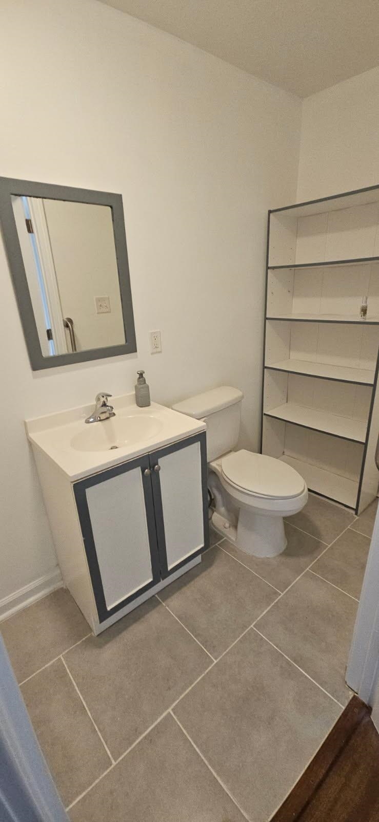 502 James Avenue Covington, TN 38019 - Photo 20 of 40 a bathroom with a toilet sink and mirror