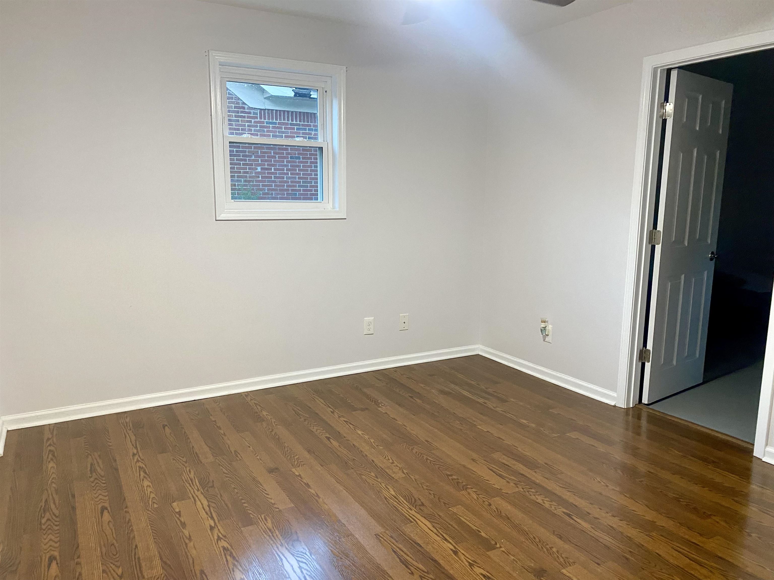 502 James Avenue Covington, TN 38019 - Photo 25 of 40 an empty room with wooden floor and windows