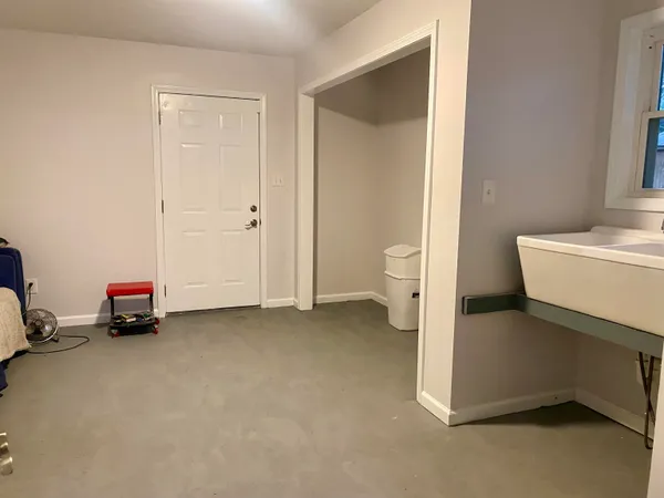 a view of a room with a baby crib and a bathroom