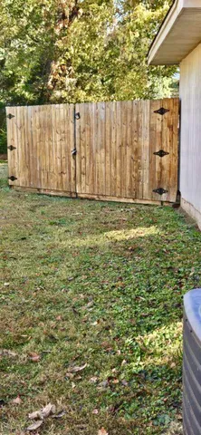 a backyard of a house with table and chairs