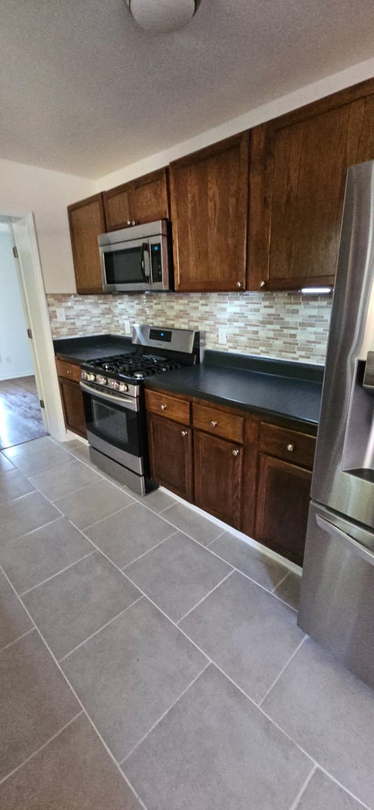 502 James Avenue Covington, TN 38019 - Photo 38 of 40 a kitchen with stainless steel appliances granite countertop a stove microwave and sink