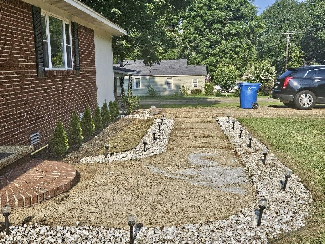 502 James Avenue Covington, TN 38019 - Photo 7 of 40 a view of a backyard that has a fountain and a plants