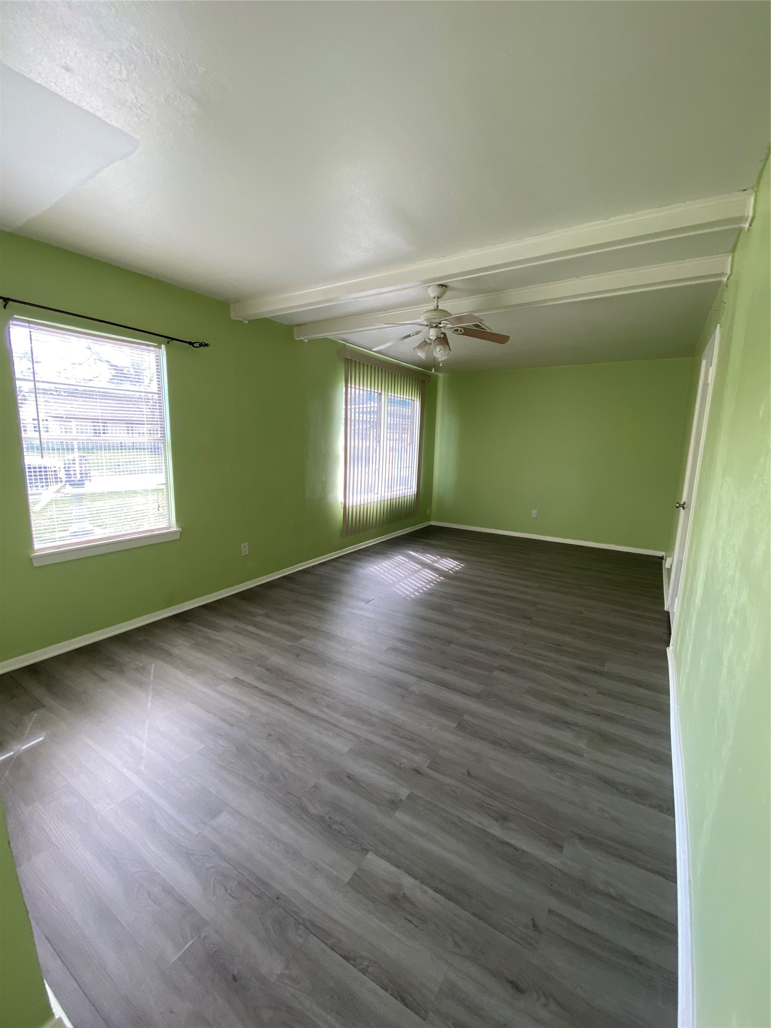 15513 Vonnet Street Channelview, TX 77530 - Photo 6 of 10 an empty room with wooden floor closet and windows