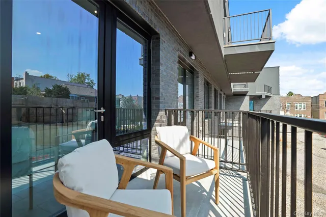 a view of a chair and tables in the balcony