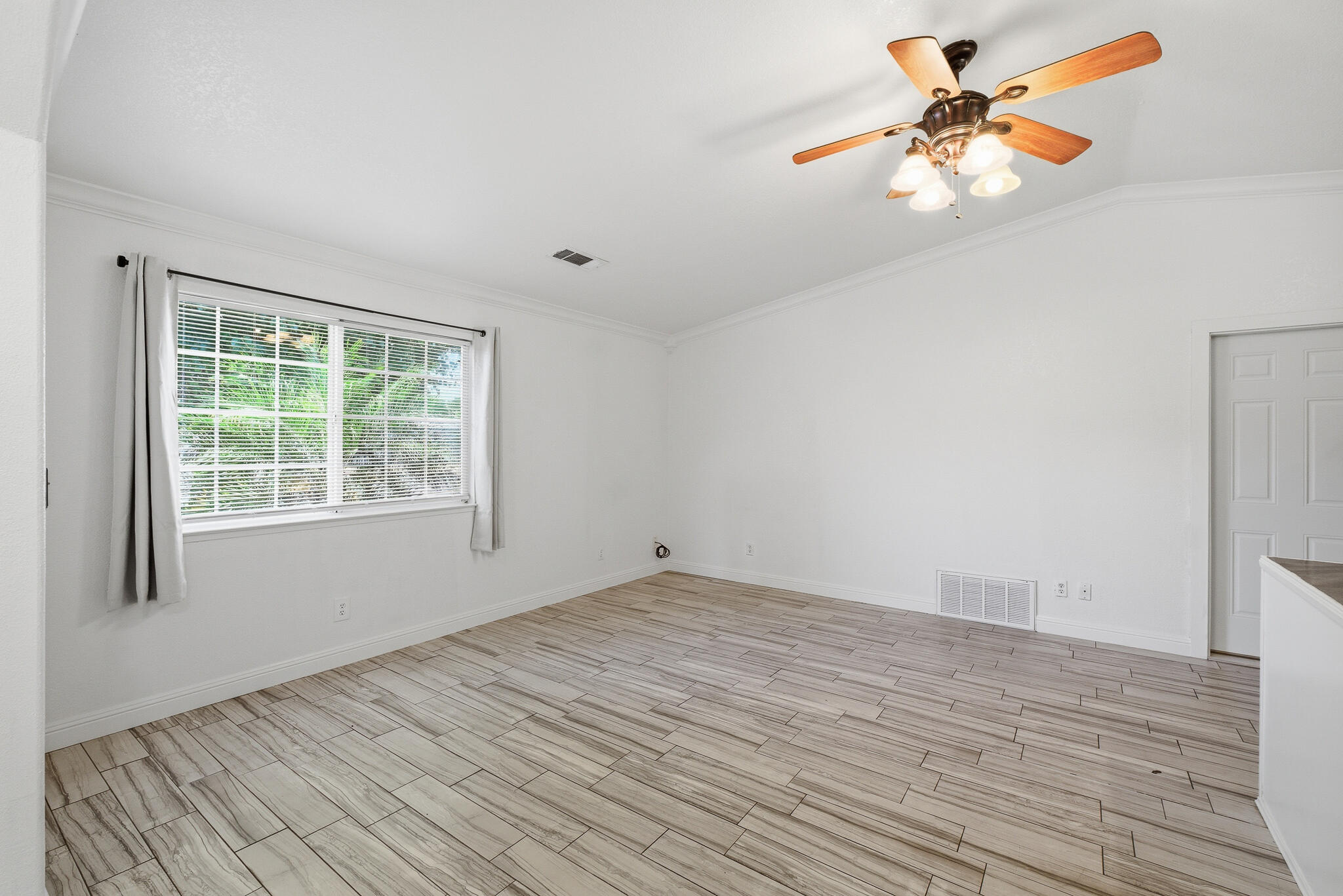 618 Birdsong Court Exeter, CA 93221 - Photo 7 of 62 wooden floor in an empty room with a window