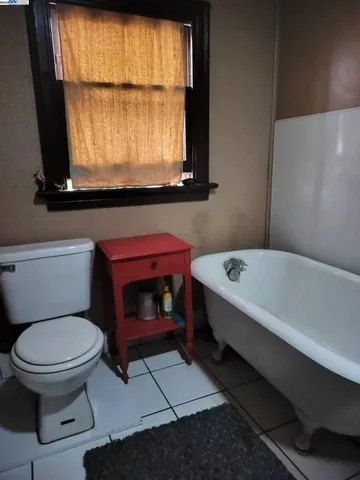 a bathroom with a toilet a sink and a window