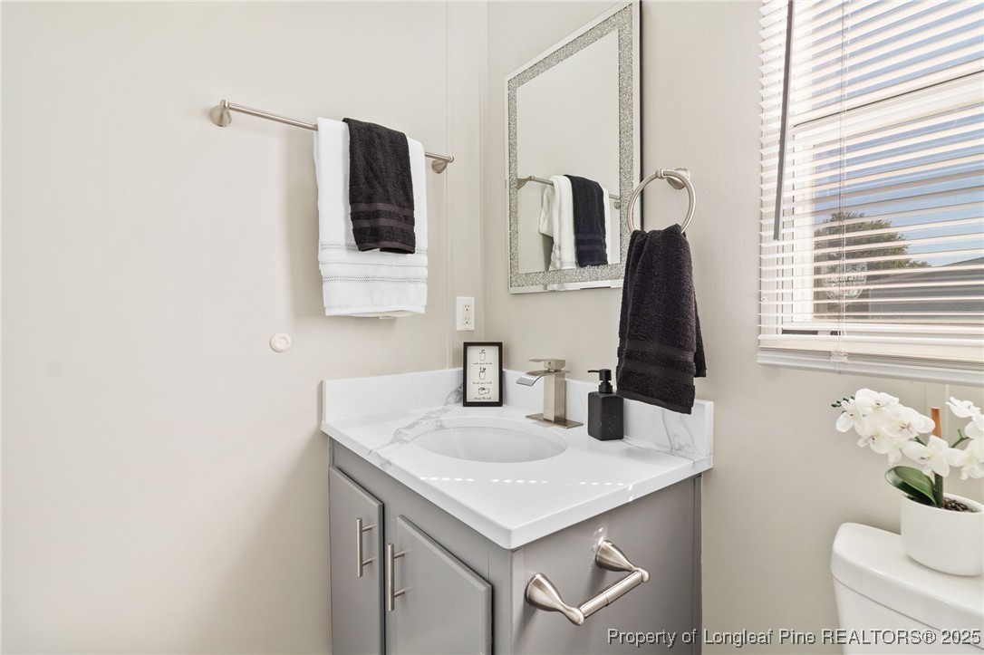 1334 East Green Springs Road Parkton, NC 28371 - Photo 24 of 32 a bathroom with a sink and a mirror
