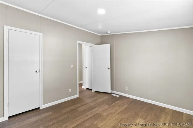 an empty room with wooden floor