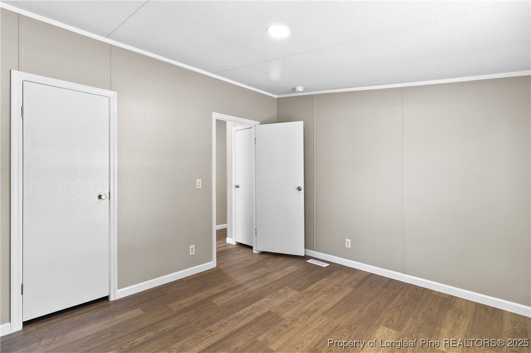 1334 East Green Springs Road Parkton, NC 28371 - Photo 26 of 32 an empty room with wooden floor