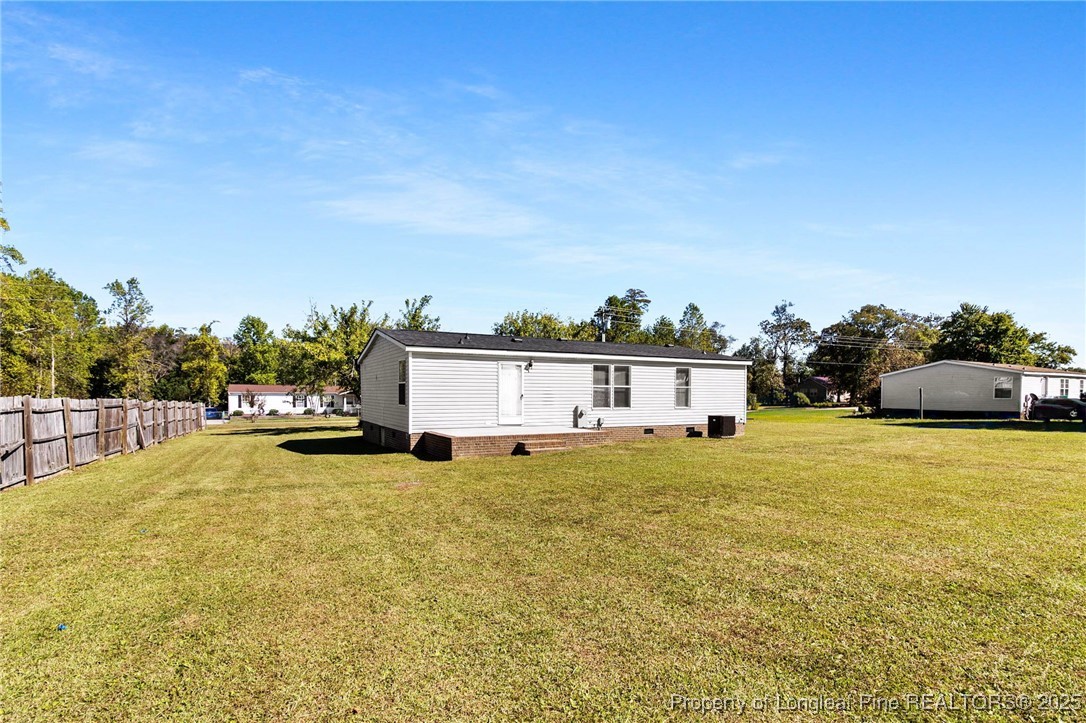 1334 East Green Springs Road Parkton, NC 28371 - Photo 28 of 32 a view of a house with a yard
