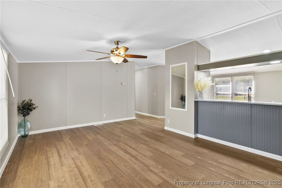 1334 East Green Springs Road Parkton, NC 28371 - Photo 3 of 32 an empty room with wooden floor and natural light