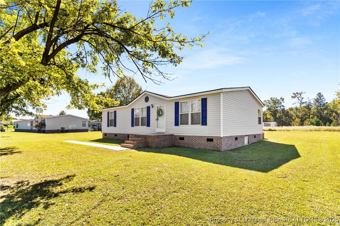 1334 East Green Springs Road Parkton, NC 28371 - Photo 32 of 32 a view of a house with a yard