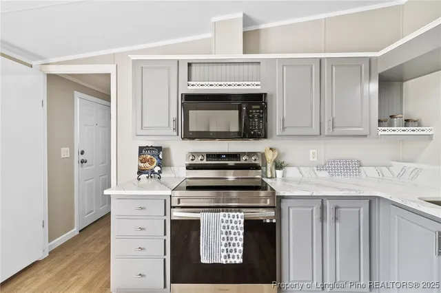 a kitchen with stainless steel appliances granite countertop a stove and a microwave